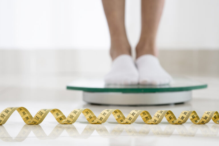 An expert medical team coordinating care inside a state-of-the-art operating theater, focusing on precision bariatric care.